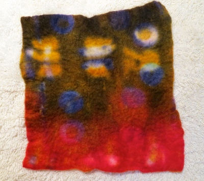Second piece of felt applied with resists and dyed in a dye-bath.